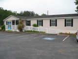 A single-story beige building with a ramp.